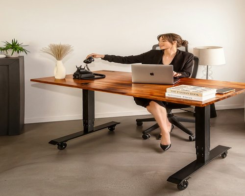 office worker stretching arms sitting at desk